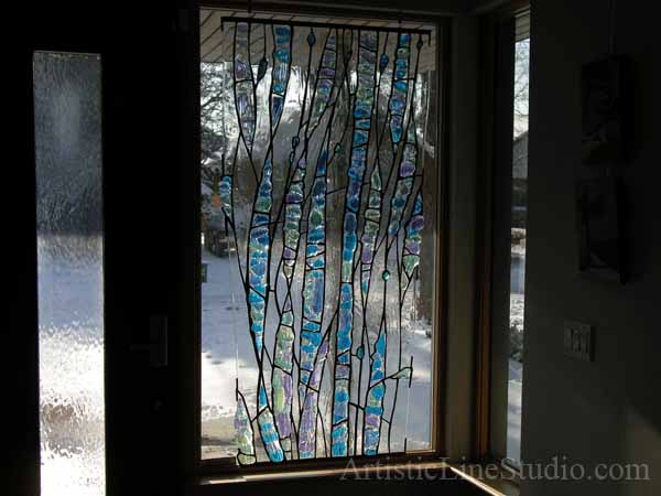 Stained, fused and leaded glass sculpture for the foyer window of a private residence