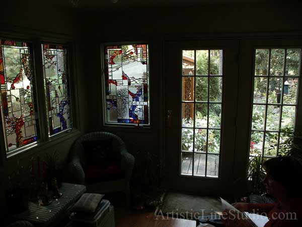 Stained and leaded glass suspended panels with nuggets and bevelled glass for solarium room windows