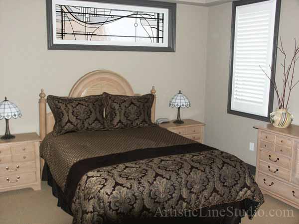 Stained and leaded glass bedroom window with jewels and beveled glass adding prinacy and beauty