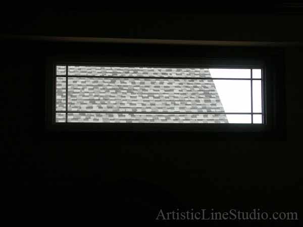 Stained and leaded glass bedroom window with jewels and beveled glass adding prinacy and beauty