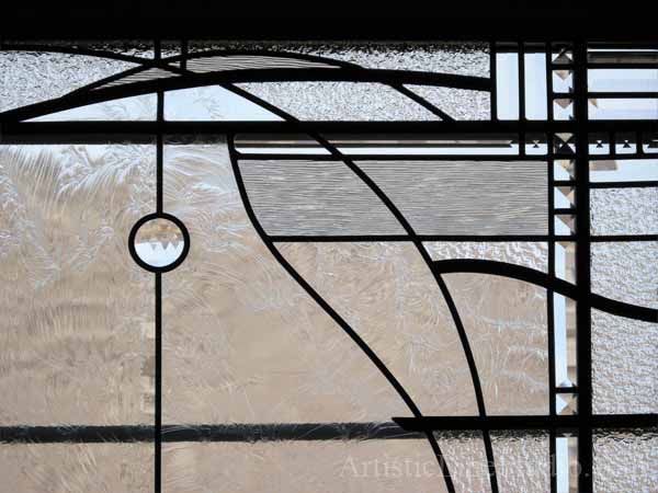 Stained and leaded glass bedroom window with jewels and beveled glass adding prinacy and beauty