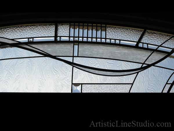Stained and leaded glass bedroom window with jewels and beveled glass adding prinacy and beauty