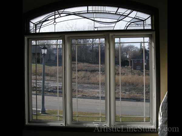 Stained and leaded glass bedroom window with jewels and beveled glass adding prinacy and beauty