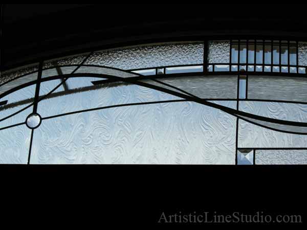 Stained and leaded glass bedroom window with jewels and beveled glass adding prinacy and beauty