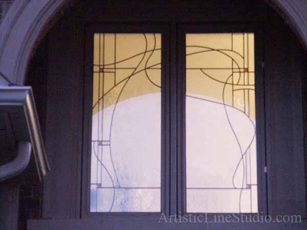 Stained and leaded glass bathroom window with jewels and beveled glass adding prinacy and beauty
