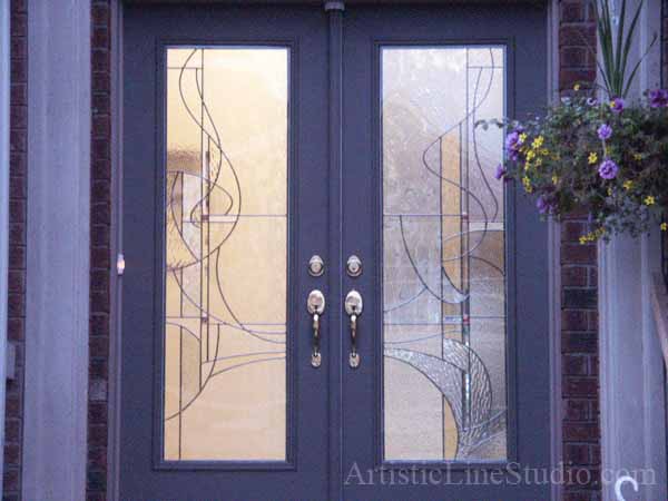 Stained and leaded glass enrance door inserts with jewels and beveled glass adding prinacy and beauty