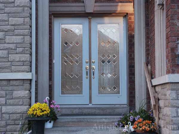 Stained and leaded glass enrance door inserts with jewels and beveled glass adding prinacy and beauty
