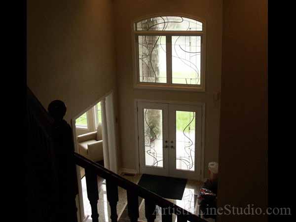 Stained and leaded glass front entrance system with jewels and beveled glass adding prinacy and beauty