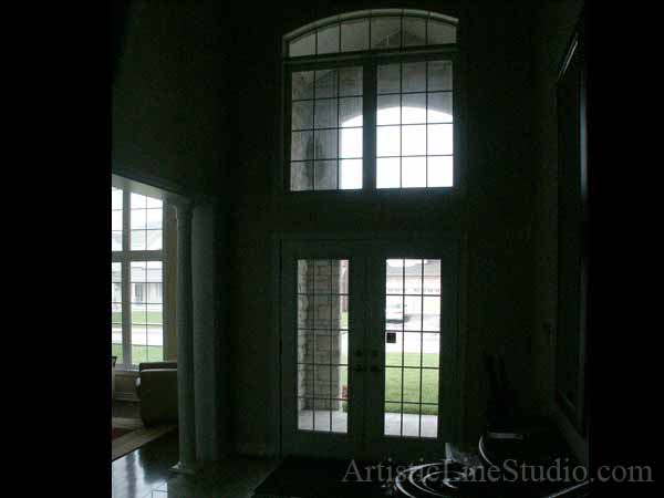 Stained and leaded glass front entrance system with jewels and beveled glass adding prinacy and beauty