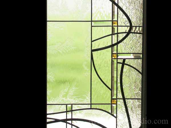 Stained and leaded glass front entrance system with jewels and beveled glass adding prinacy and beauty