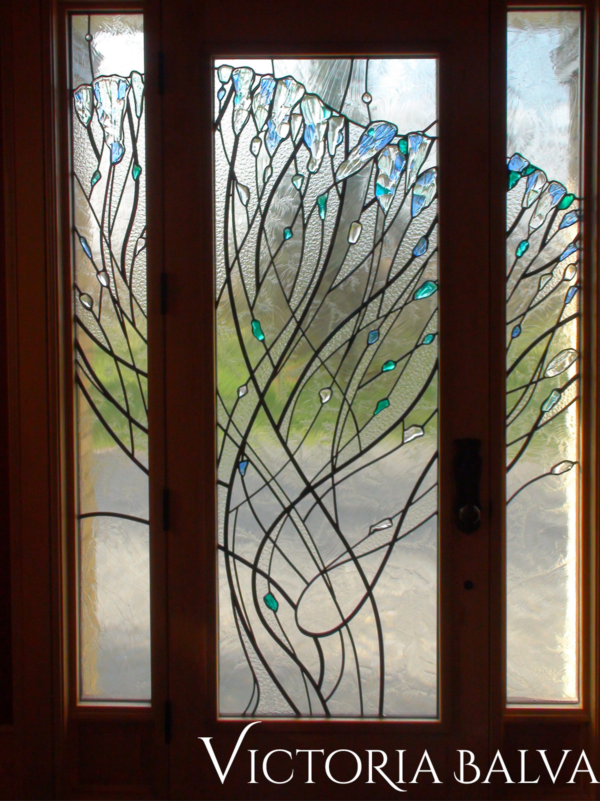Stained, fused and leaded glass doorlights for the entrance after installation in abstract modern style