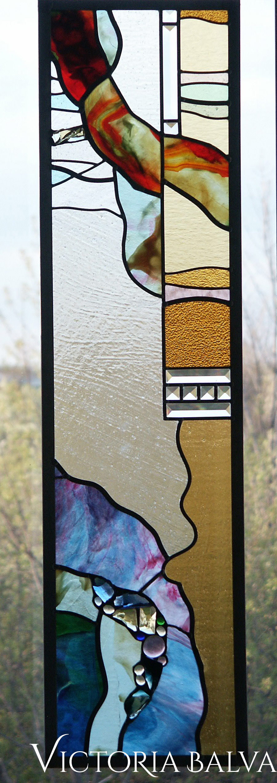 Stained and leaded glass suspended panels for a family room with fireplace a private recidence